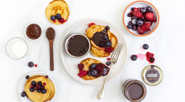 VEGAN PANCAKES WITH NUTTY CHOCOLATE DRIZZLE AND BERRIES